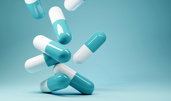 Blue and white pharmaceutical capsules inspected using BiSmart 2.0 AI system for precision quality control, defect detection, and compliance assurance.